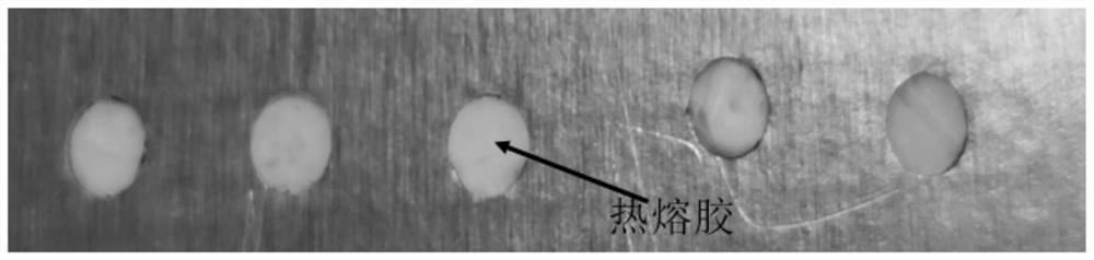 Hot melt adhesive assisted laser shock peening method for small hole of airplane structural part