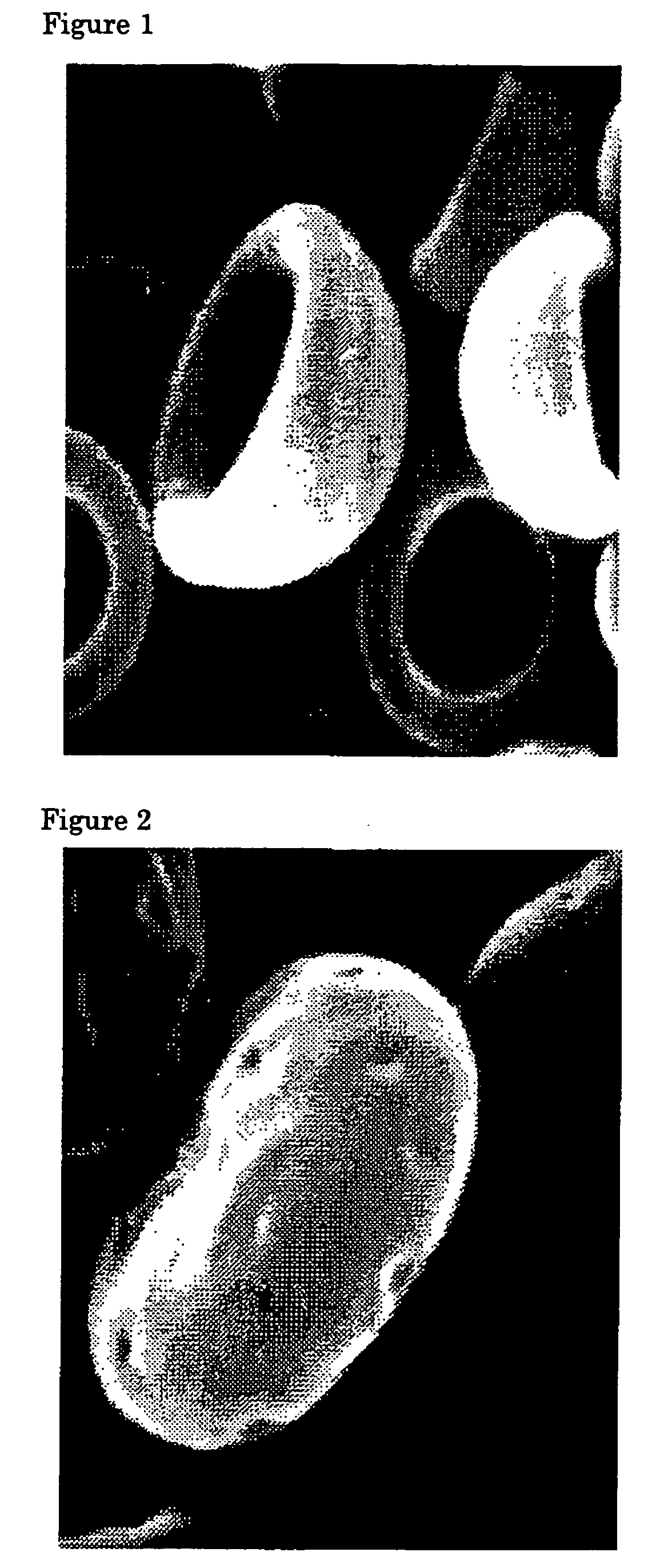 Flat particles and process for production thereof