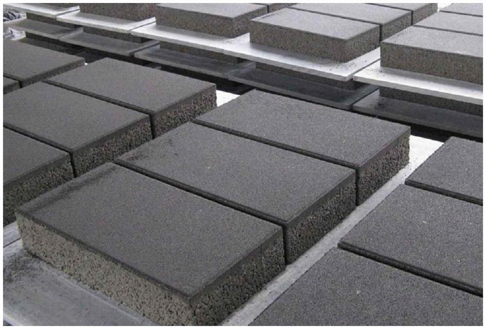 Geopolymer water-permeable concrete brick containing biomass charcoal