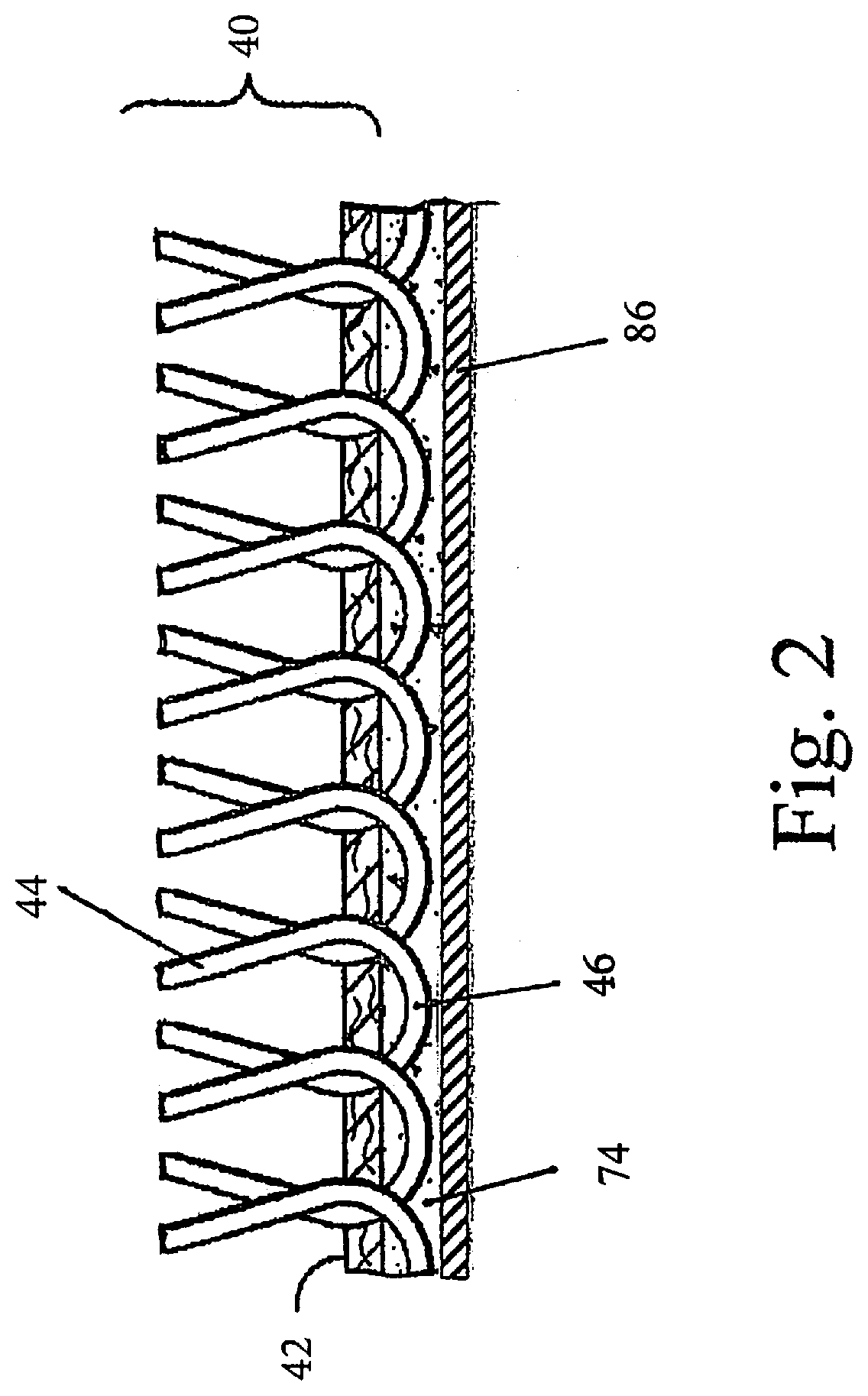 Water permeable artificial turf and method of making same