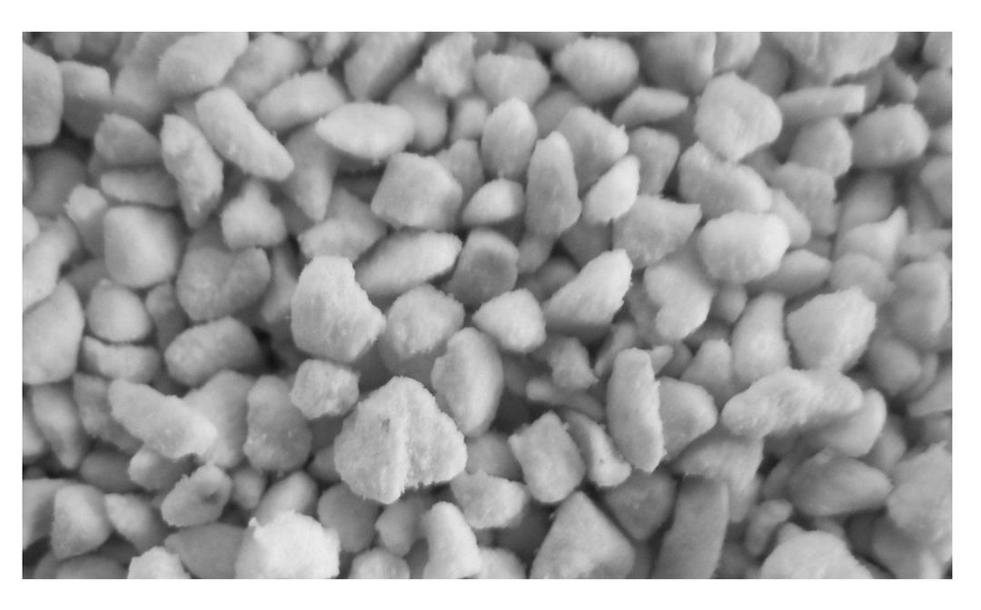 Carrier material for active ingredient of floatable agrochemical preparation and floatable agrochemical preparation