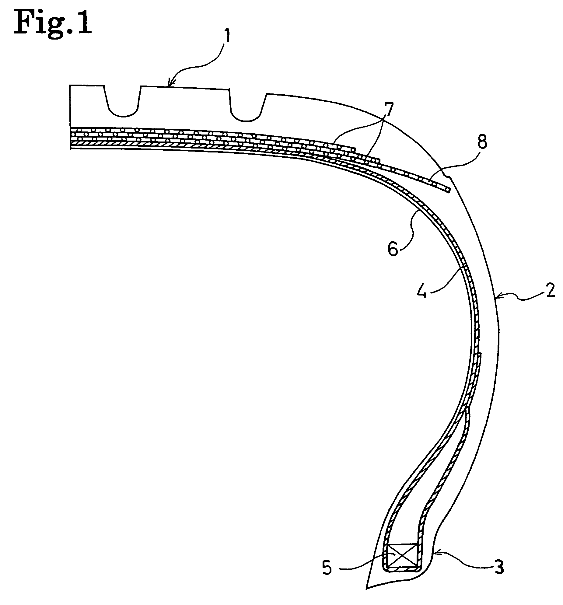 Pneumatic tire with wound cord layer between carcass layer and belt layers