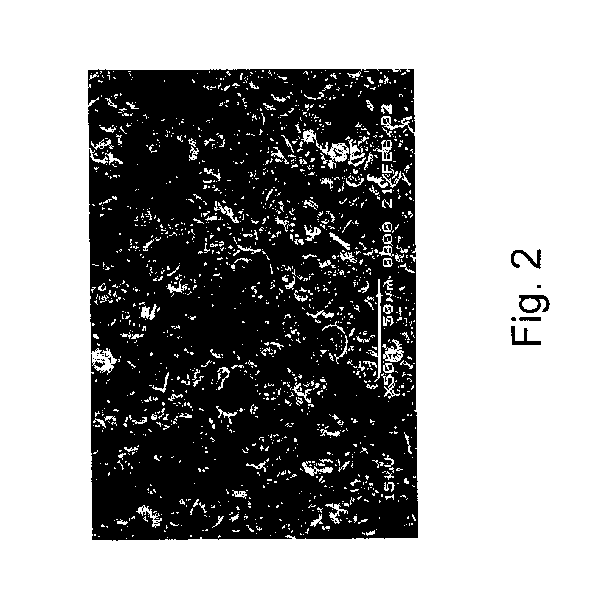 Friction material with friction modifying layer having symmetrical geometric shapes