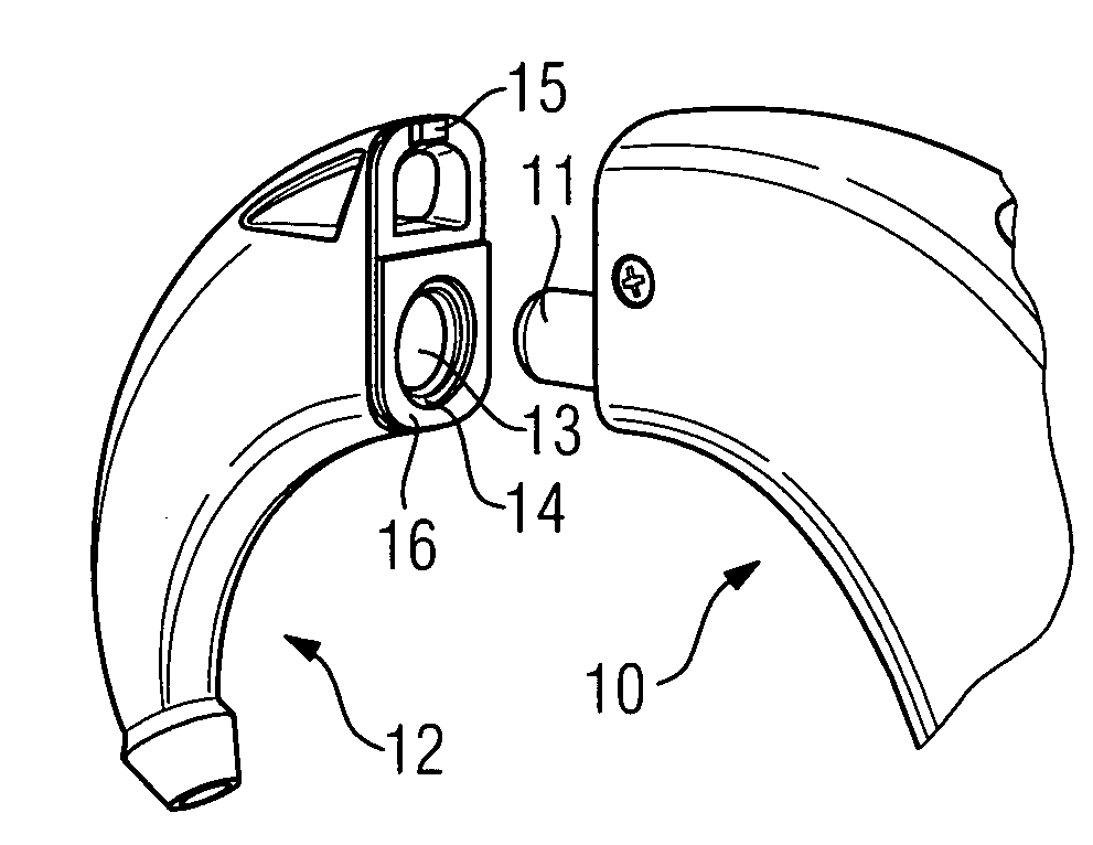 Behind-the-ear hearing device with a magnetically-attached ear hook